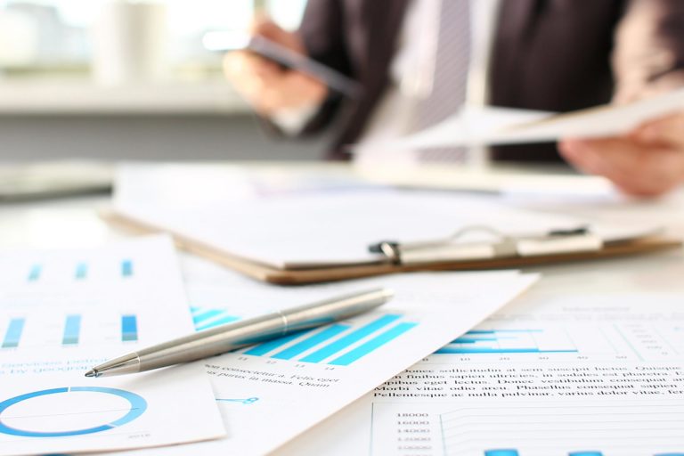 photo of a man in a suit consulting graphics