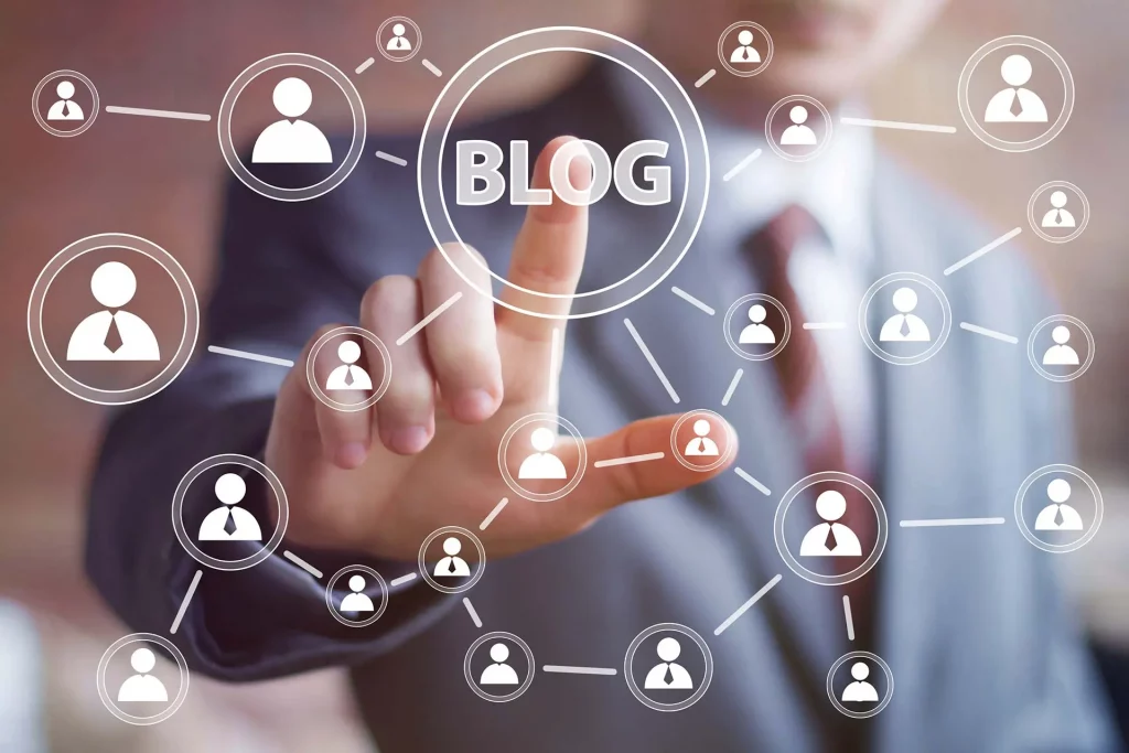 Photo of a man in a suit with a red tie, pressing the word blog, on an interactive screen